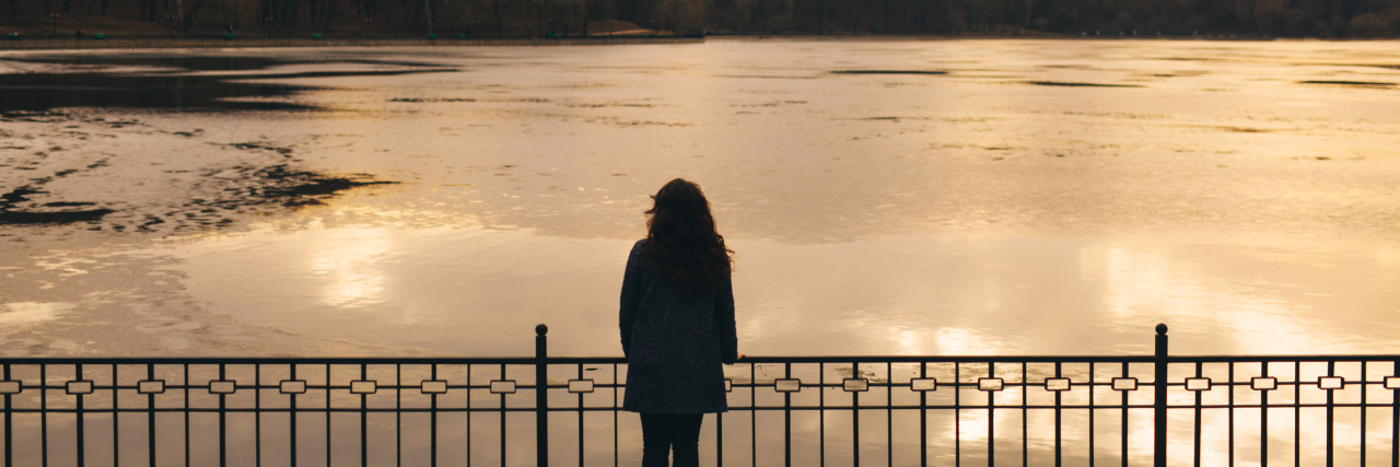 Picking Up the Pieces After Child Loss Lonely woman alone in winter at sunset