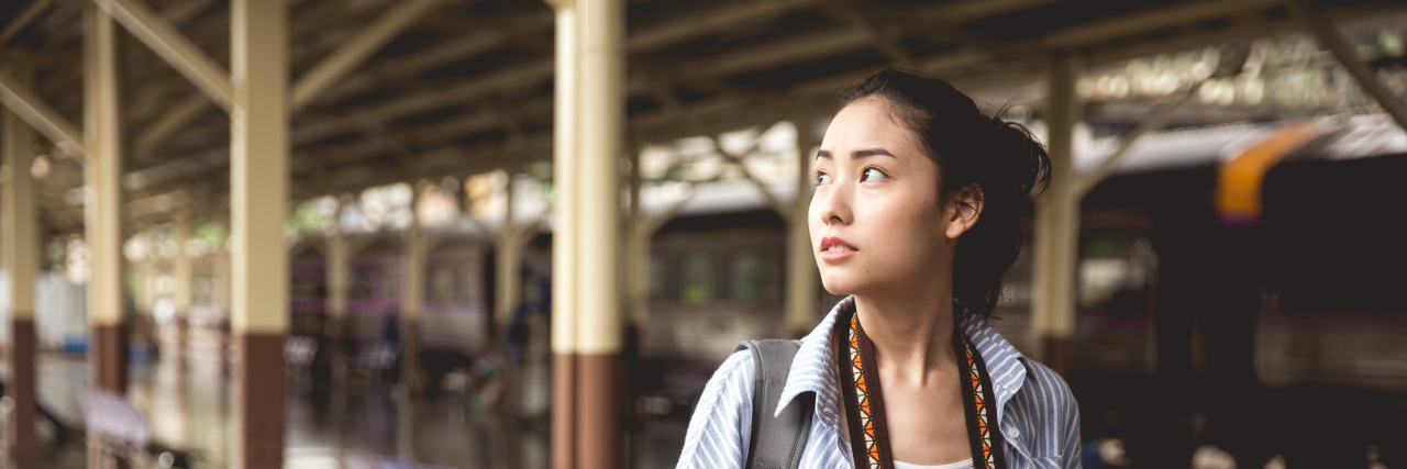 The 6 Things I Keep in My Mental Illness Coping Toolbox young asian woman holding a camera and backpack