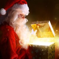 Santa Claus Opening Christmas Present With Shiny Stars