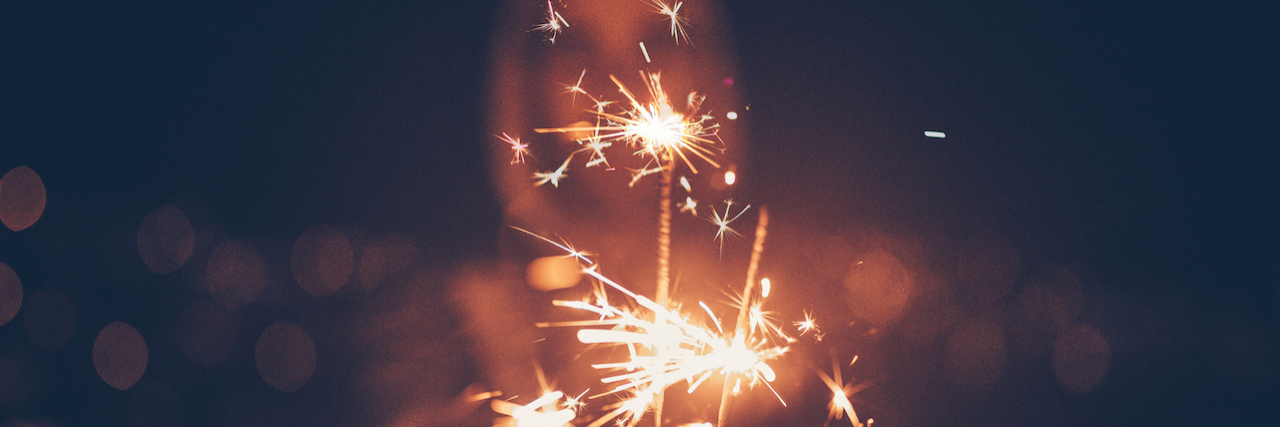 5 Resolutions to Bust Mental Health Stigma in 2018 Woman holding sparklers