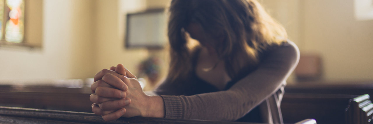 When Christians Say God Will Heal Your Illness If You Pray woman praying in a church