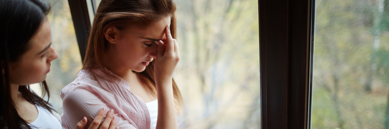 What I Need You to Know About Supporting Me With My Chronic Illness A woman comforting her friend.