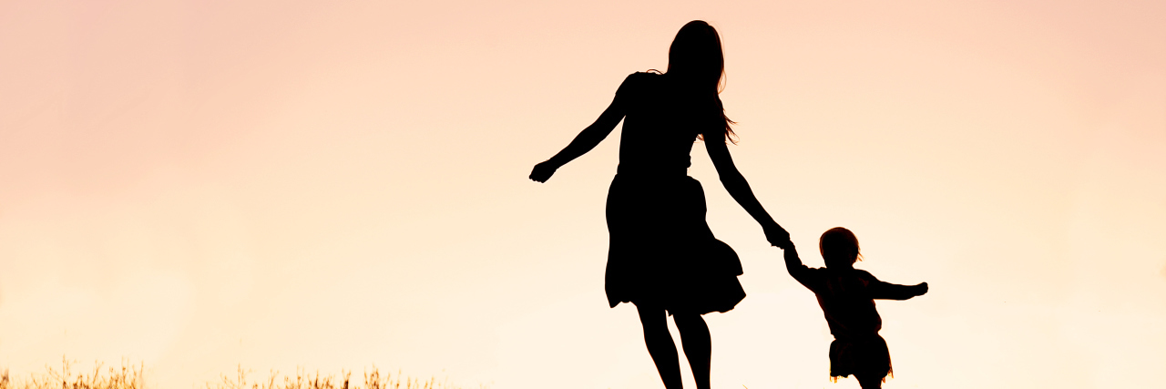 Selective Dorsal Rhizotomy as a Mom With Cerebral Palsy Silhouette of mother and baby playing.