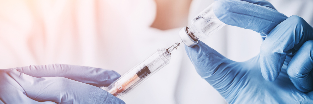 Studies Show Promise for New Migraine Prevention Drugs doctor holding needle, preparing injection