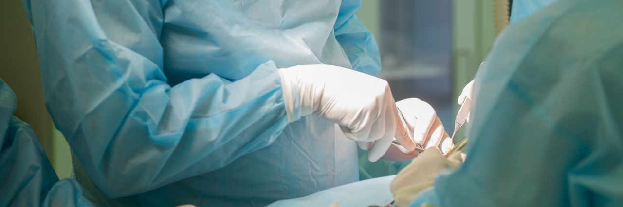 Surgeon Simon Bramhall Burns His Initials on Patients' Livers two surgeons using tools during surgery