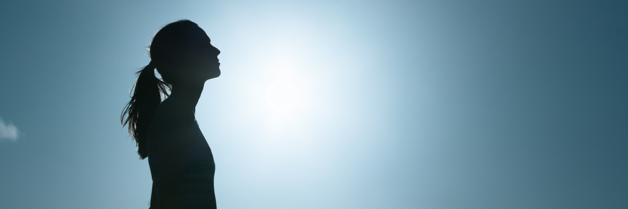 Mourning and Grieving After My Gastroparesis Diagnosis silhouette of woman against the blue sky