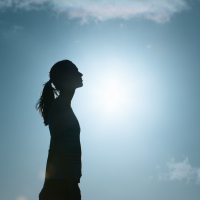silhouette of woman against the blue sky