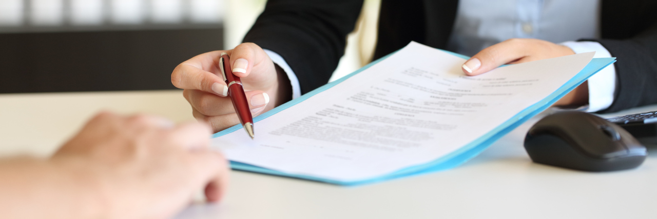 The Agreement Between Me and Bipolar Disorder close up of woman holding pen for man to sign contract
