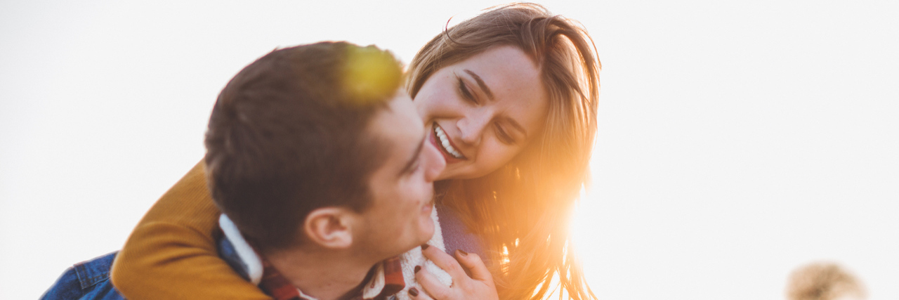What Your Partner Doesn’t Realize You’re Doing Because of Your Anxiety a young couple having fun in field in sunset