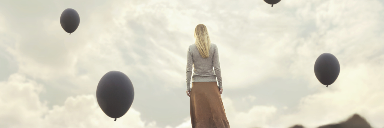 What Made Me Finally Seek Treatment for My Anxiety lonely woman walking towards infinity in a surreal place
