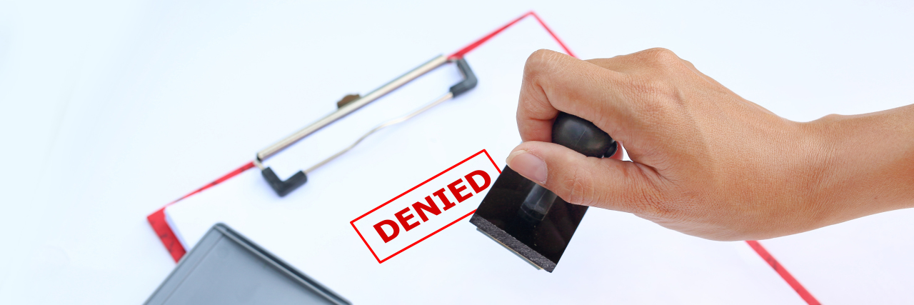 Getting Cancer in a Medicaid Non-Expansion State Hand stamping DENIED on paper.