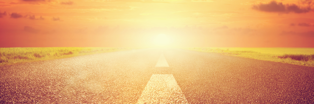 Improving Research for Stiff Person Syndrome Long empty asphalt road towards sunset sun. Wide perspective, conceptual way