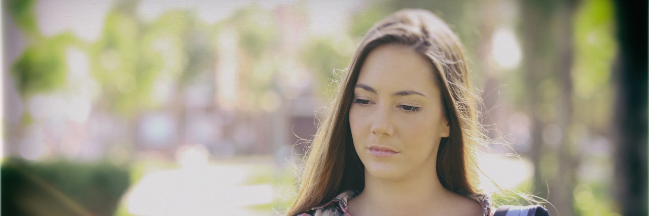 College Struggles With Chronic Illness Sad student walking on college campus.