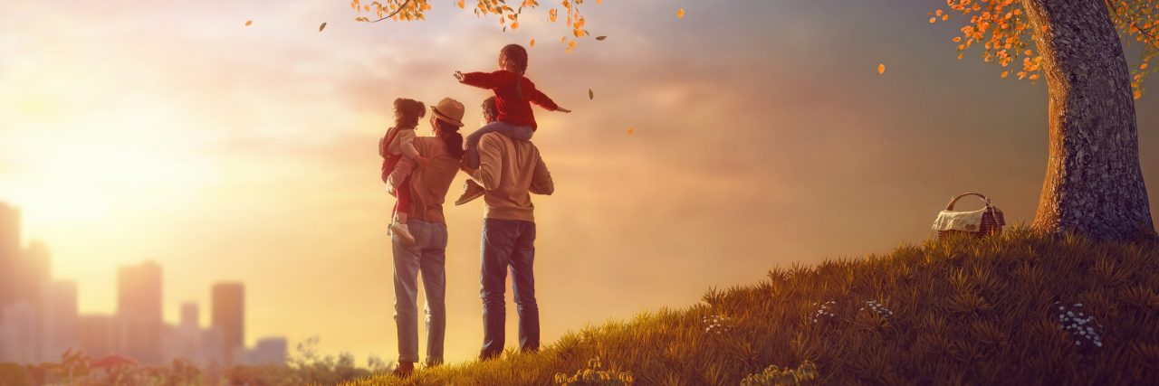 Happy family at sunset. Father, mother and two children.