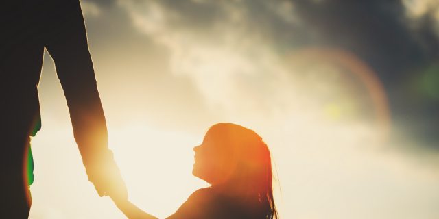 Why I Count the 'Small Mercies' With Morquio Syndrome silhouette of little girl holding parent hand at sunset sky