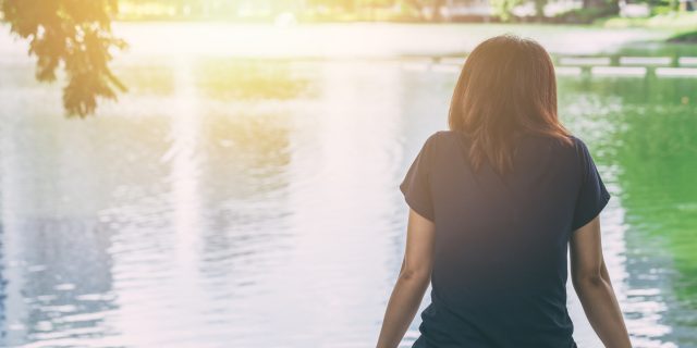 The Day I was Diagnosed With a Rare Lung Disease woman sitting alone feeling lonely and thinking missing someone looking out at water lake