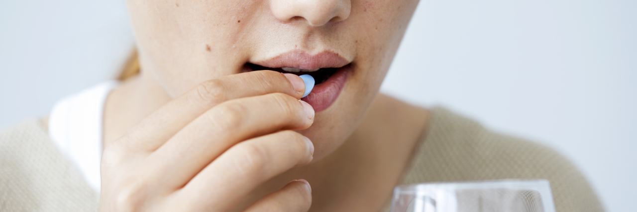 5 Myths About Antidepressants I Don't Believe Young woman taking a pill