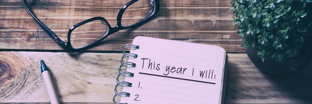 New Year's Resolution Ideas for Eating Disorder Recovery new year's resolutions on notepad sitting on wooden table