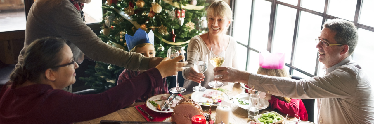 Having Less Money to Spend During the Holidays Due to Illness family eating christmas dinner