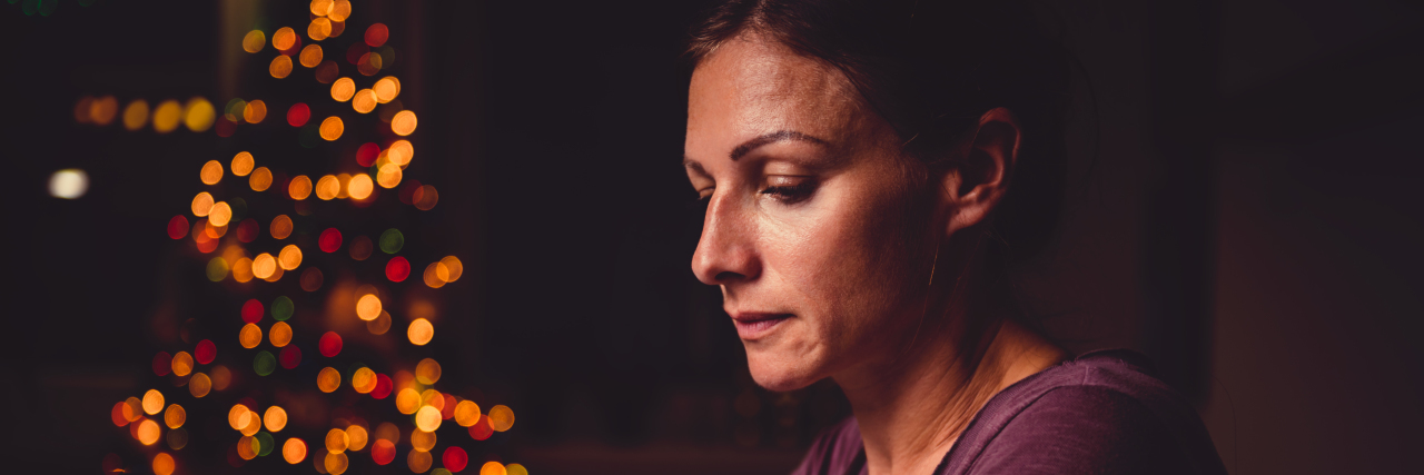 When Having No Family Affects Your Mental Health During the Holidays Worried woman working late night at the home office