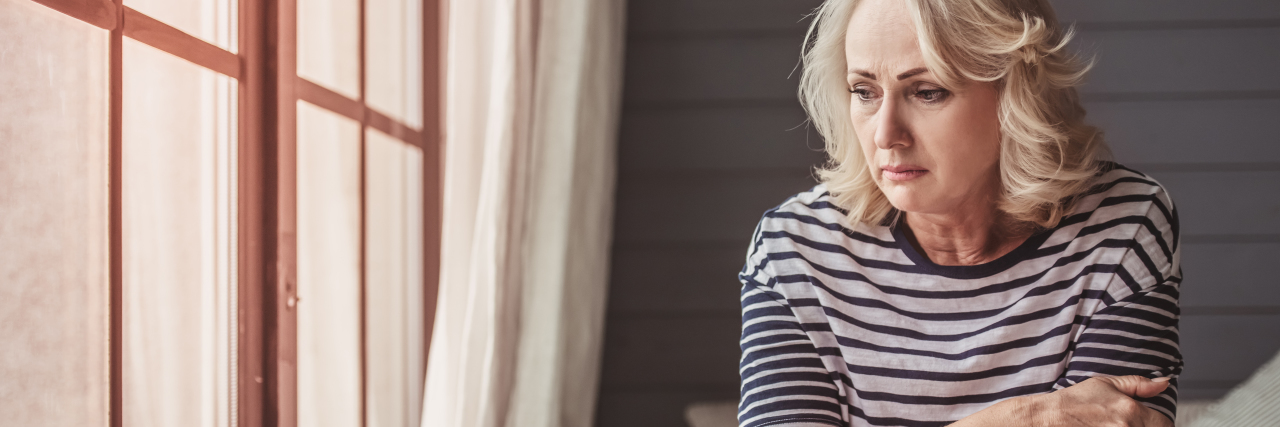 The Difficulties of Other People Not Understanding Dercum's Disease troubled woman sitting on her couch