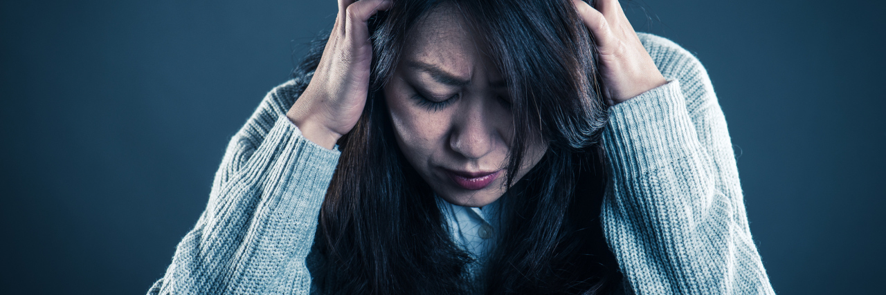 How to Cope With Anxiety in Borderline Personality Disorder middle age asian woman distress