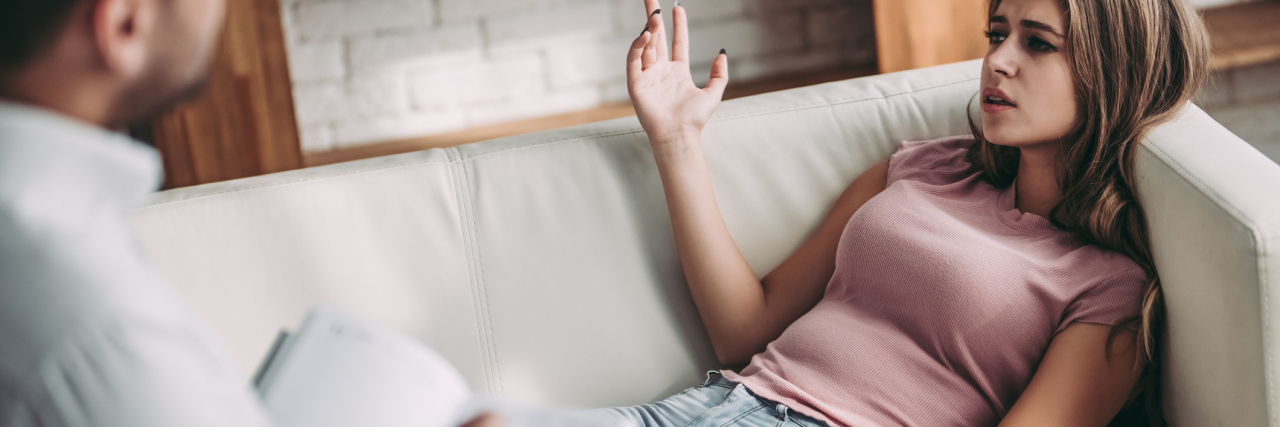 Why My Preconceived Notions About Mental Health Therapy Were Wrong young woman lying on sofa during therapy session