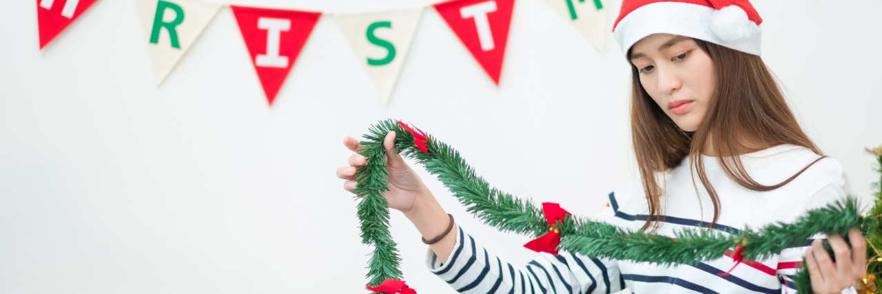 How to Survive Christmas With Borderline Personality Disorder asian woman at christmas looking upset