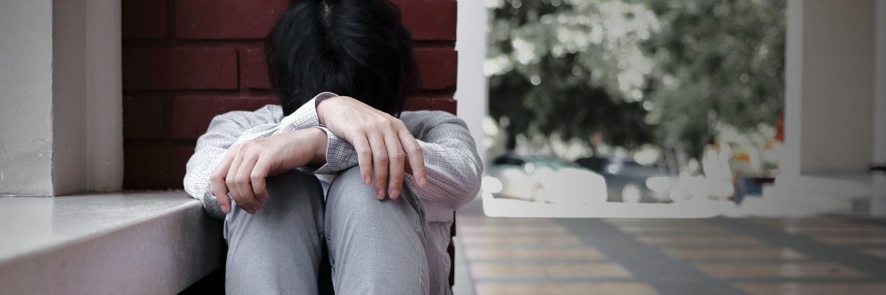 What Makes Bipolar Treatment So Difficult young asian man frustrated sitting on floor depressed