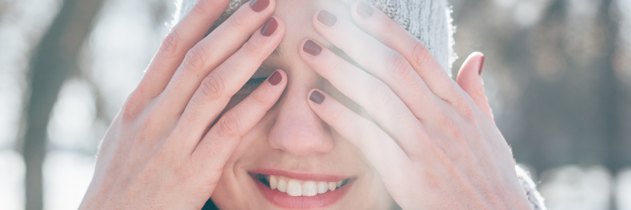 5 Ways I'm Making the Holidays With Mental Illness Different This Year Beautiful young woman having fun in the park on winter sunny day