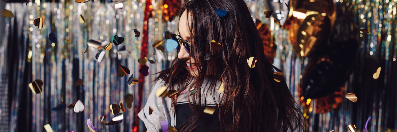 Why a New Year Doesn't Have to Mean a New You Woman with confetti falling down