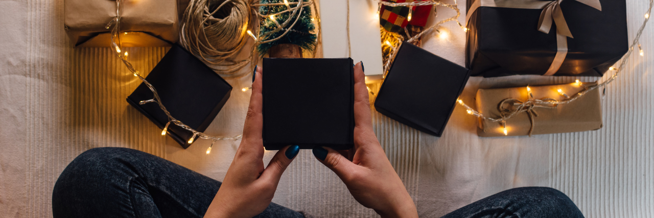 Overhead view of woman holding wrapped Christmas gift