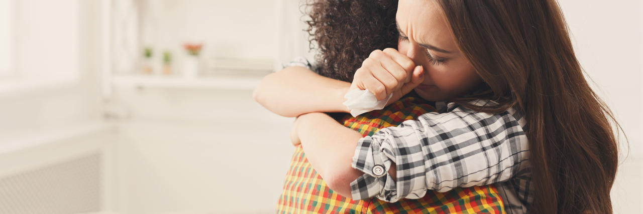 Ways to Be a Good Friend to Someone With Depression woman hugging depressed friend at home support