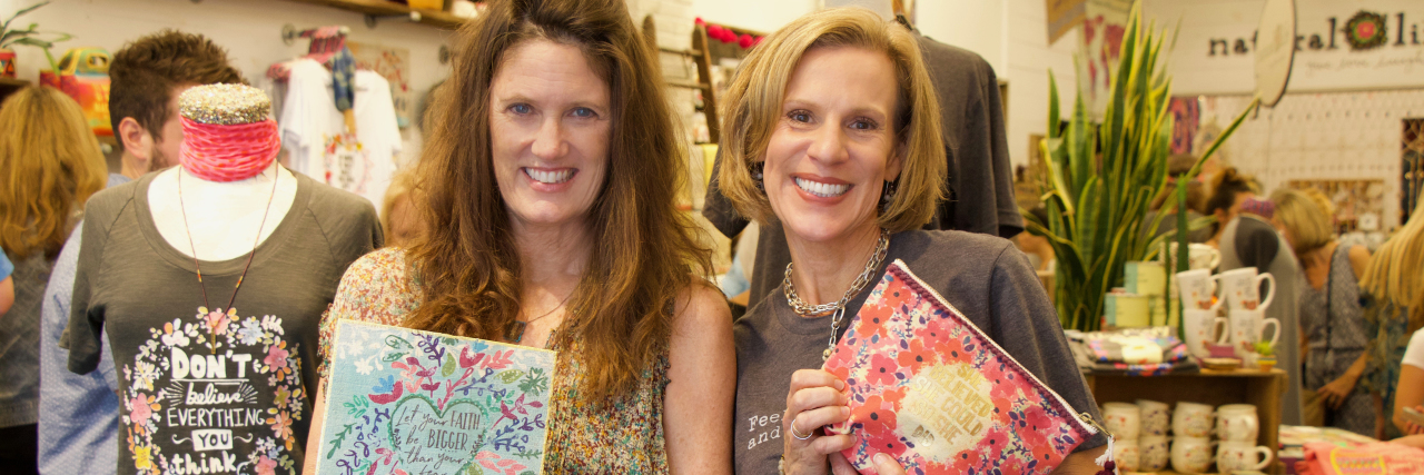 How My Son's OCD Inspired the Creation of an Encouraging Product Line two women holding product from the Natural Life Fearless collection