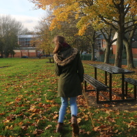 Chloe walking in a park.