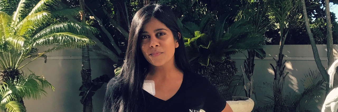 What You Don't See When You Say I Don't 'Look Sick' A photo of the writer standing in front of a pool.