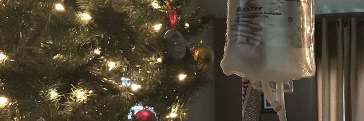 Getting in the Holiday Spirit When You're Chronically Ill An IV pole and bag in front of a Christmas tree.