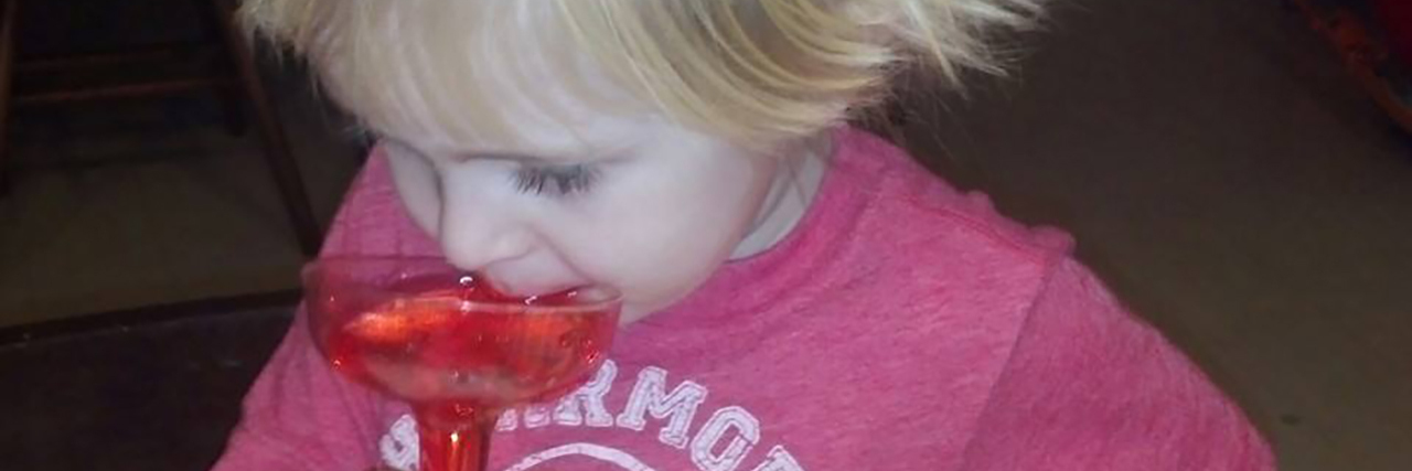 Ryan, little boy with blond hair drinking a Shirley Temple.