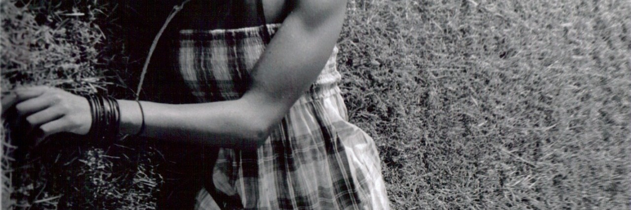 Marching to the Drum of Self-Love: A Poem About Disability Woman in plaid dress.