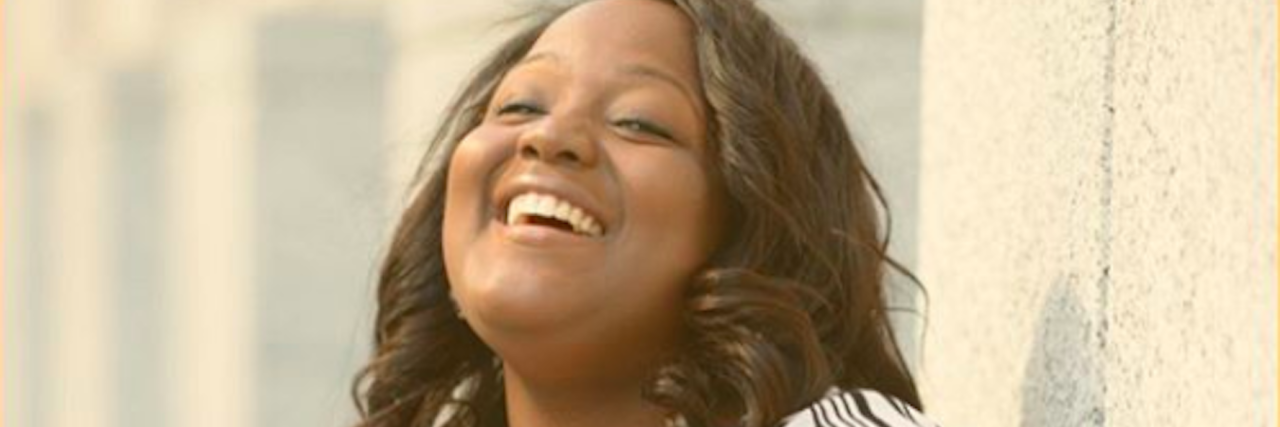 How I'm Starting Mental Health Conversations in Communities of Color portrait of black woman smiling and laughing