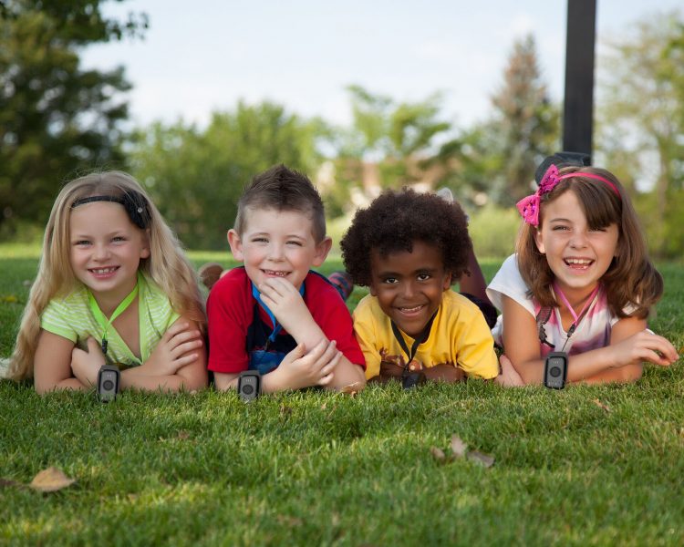 4 children wearing amber alert devices on a lanyard 