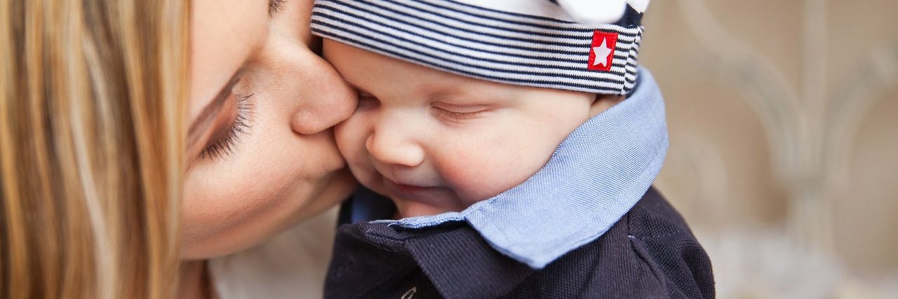 mom kissing baby