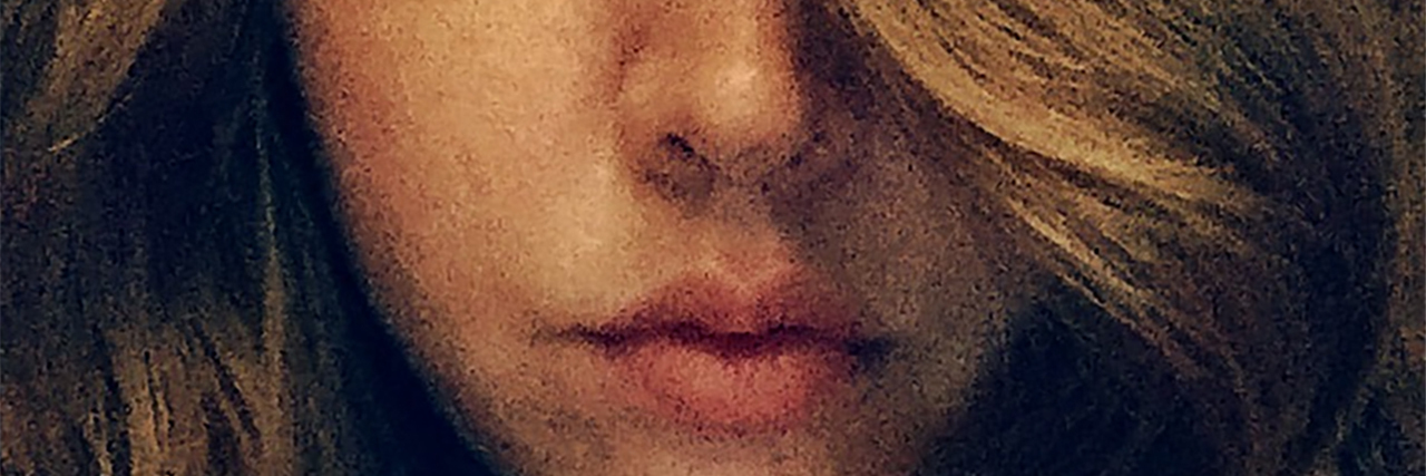 close up of woman with long hair and focus on lower half of face