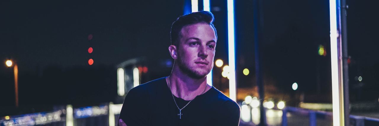 6 Ways I Combat Being Triggered man looking pensive holding arm walking over bridge during the night