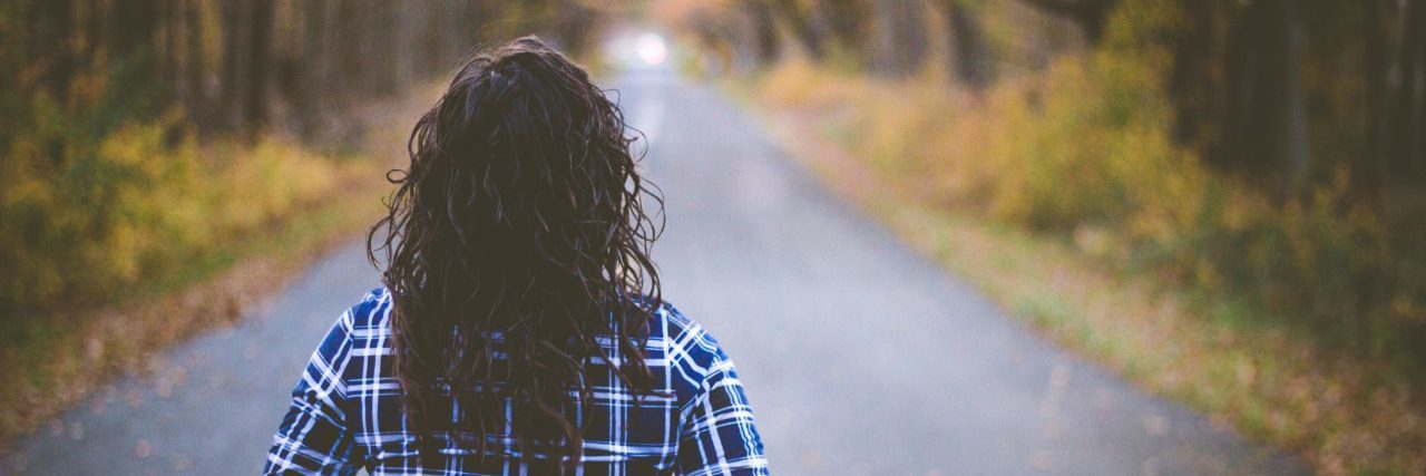 What Recovery From OCD Means to Me Woman looking down tree lined road with back to camera