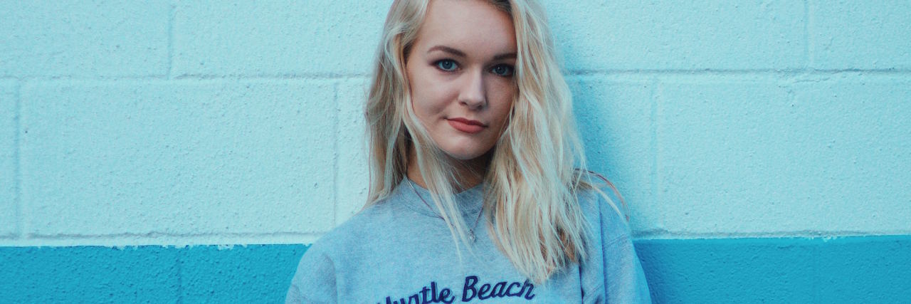 woman in front of blue wall