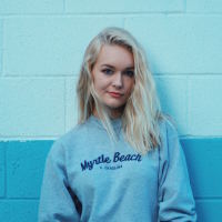 woman in front of blue wall