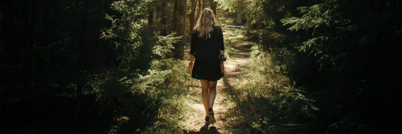 How I Began My Journey to Overcome Intrusive Thoughts of Harm young woman walking along path through forest