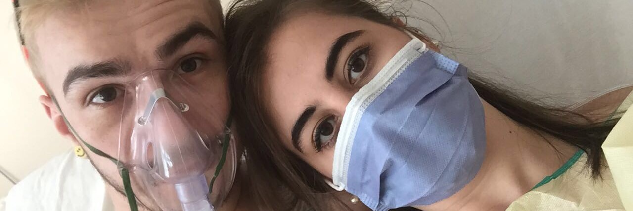 Dating Someone With Cystic Fibrosis A photo of the writer and her boyfriend. Her boyfriend is wearing an oxygen mask and she's wearing a medical mask.