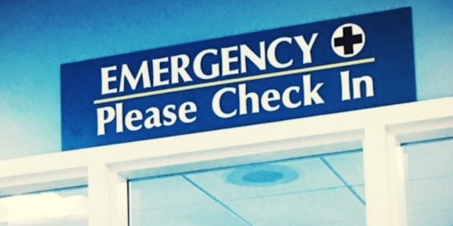 A check-in sign for an emergency room.